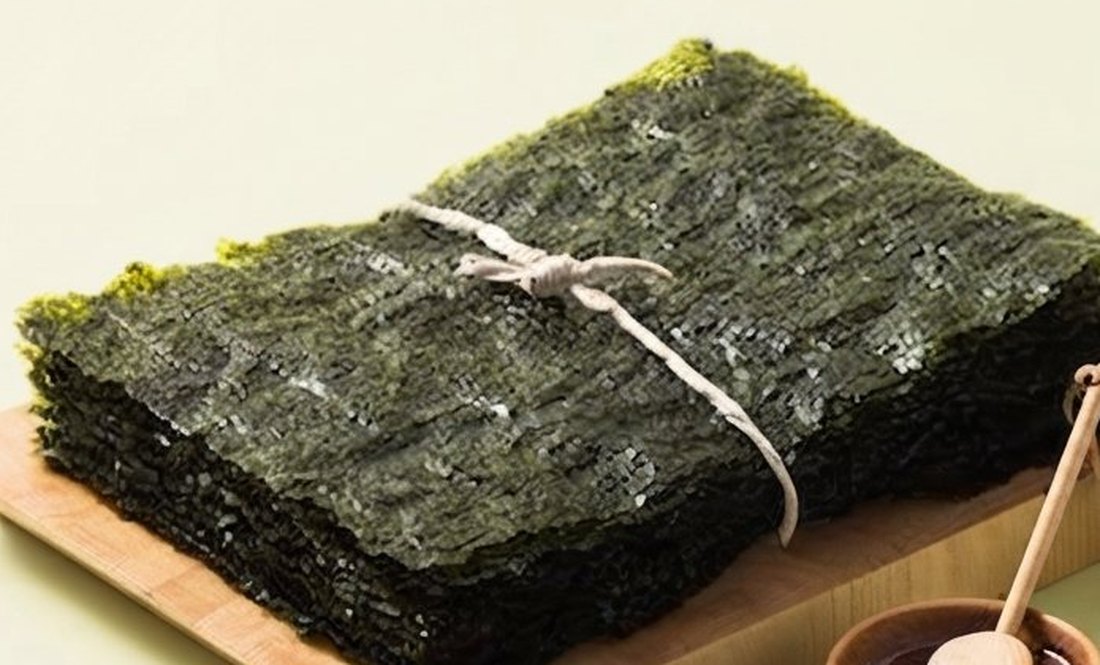 A tied stack of paper-thin roasted gim sheets